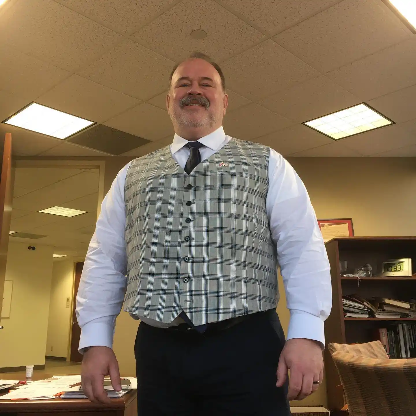 18 Winter Office Outfits for a Bigger Frame 5 Plaid Waistcoat Over a White Shirt and Navy Trousers
